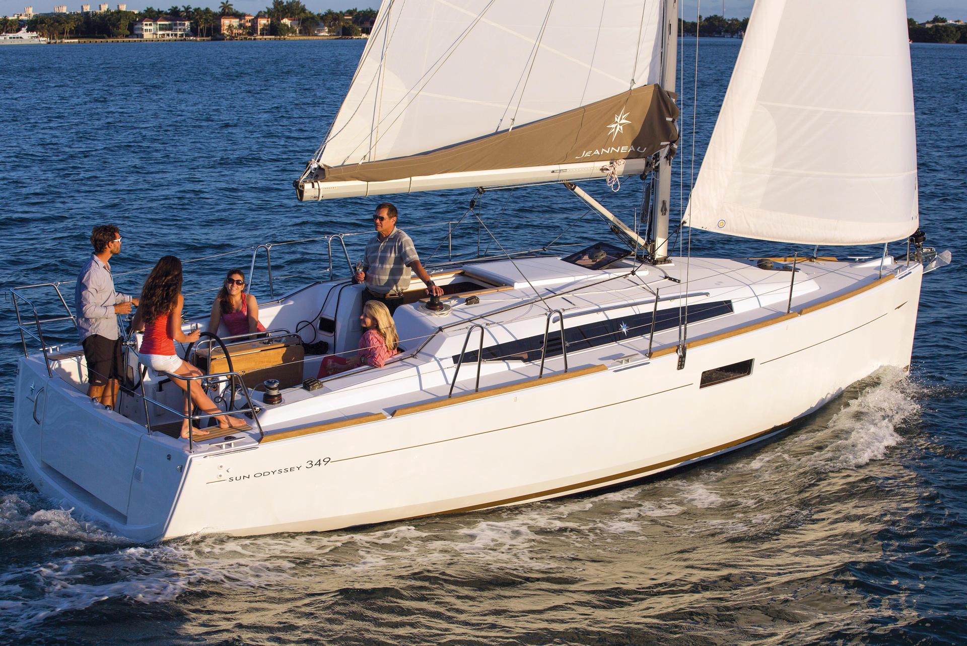 SailTime members sailing a Jeanneau Sun Odyssey on the bay at golden hour